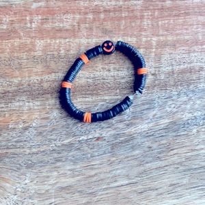 Black smiley face clay bracelet